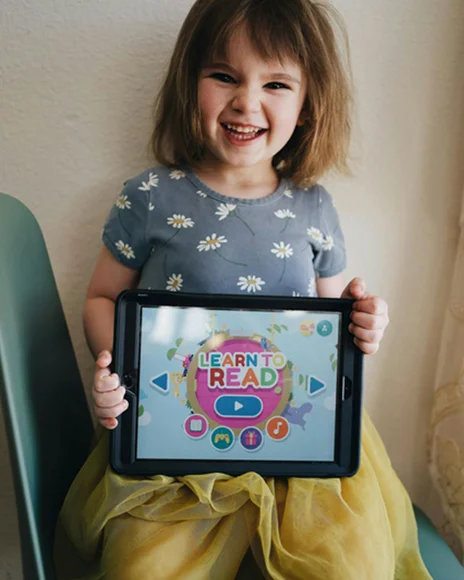 Child watching interactive phonics music video on iPad